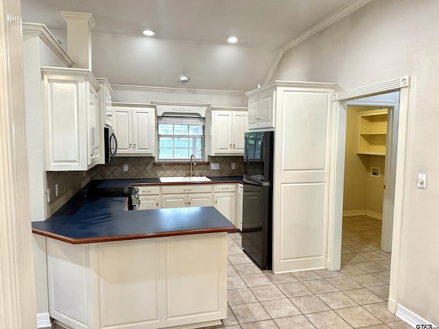 807 Brownwood Cir, Lindale, TX 75771 - kitchen with dark countertops, a sink, a peninsula, tasteful backsplash, and stainless steel microwave