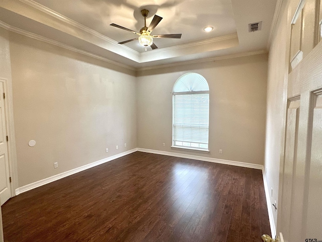 807 Brownwood Cir, Lindale, TX 75771 - spare room featuring a tray ceiling, dark wood-type flooring, a ceiling fan, ornamental molding, and baseboards