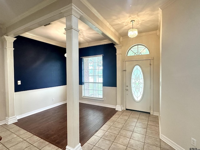 807 Brownwood Cir, Lindale, TX 75771 - entrance foyer featuring decorative columns, tile patterned flooring, ornamental molding, a wainscoted wall, and a chandelier