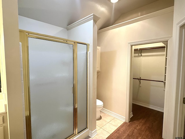 807 Brownwood Cir, Lindale, TX 75771 - bathroom featuring a spacious closet, a stall shower, toilet, and lofted ceiling