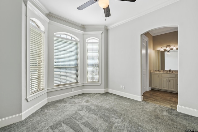 spare room featuring sink, crown molding, carpet floors, and ceiling fan