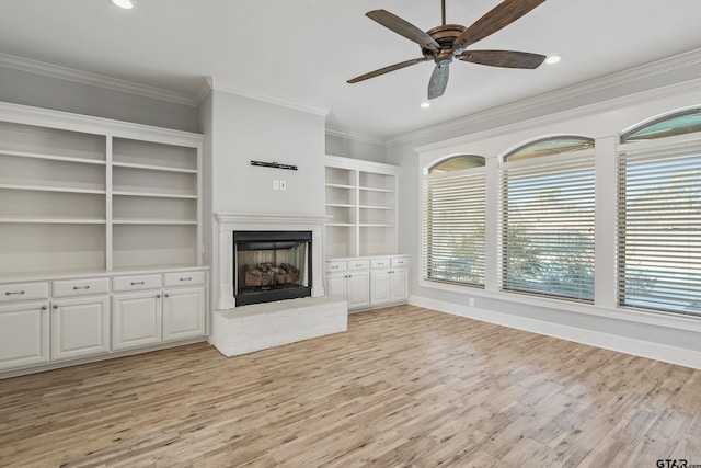 unfurnished living room with ceiling fan, ornamental molding, and light wood-type flooring