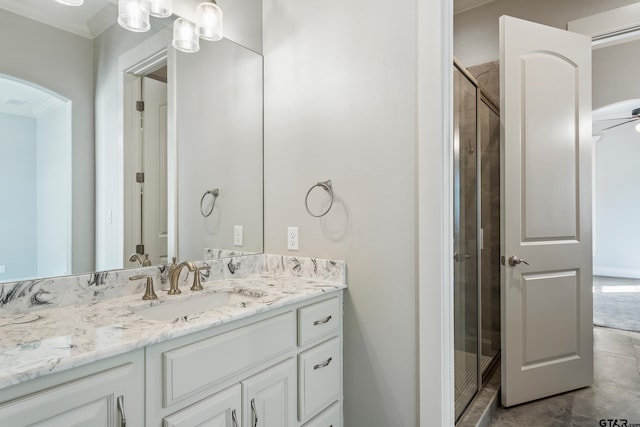 bathroom featuring vanity and a shower with shower door