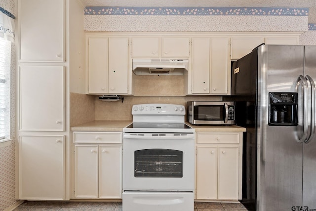 kitchen with cream cabinets and appliances with stainless steel finishes