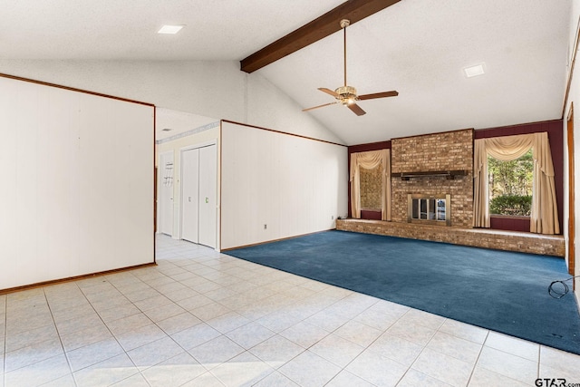 unfurnished living room with lofted ceiling with beams, ceiling fan, a textured ceiling, and a brick fireplace