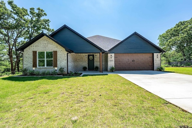 view of front of house featuring a garage, a front lawn, concrete driveway, and brick siding