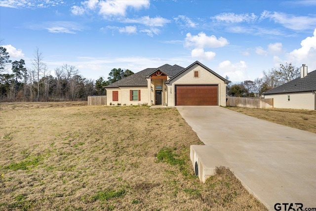 view of front of house featuring a garage and a front lawn