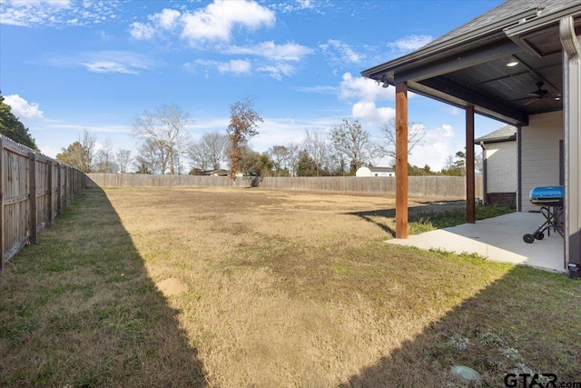 view of yard with ceiling fan and a patio area