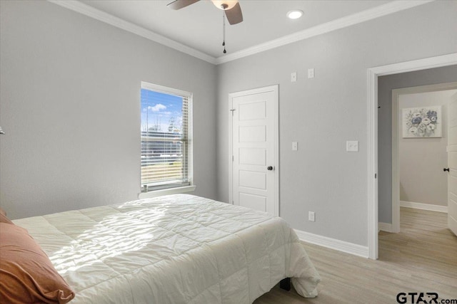 bedroom featuring crown molding, ceiling fan, and light wood-type flooring