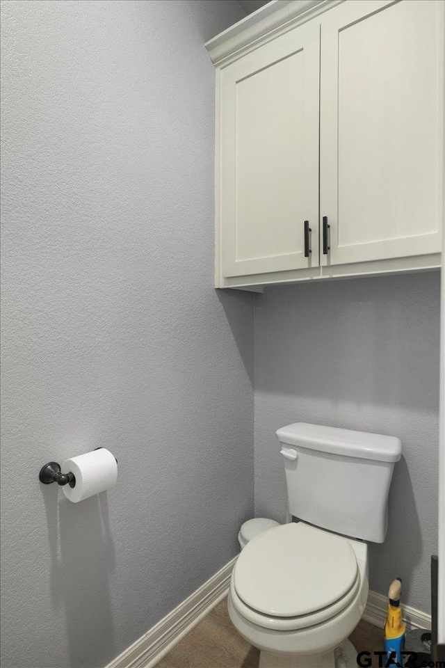 bathroom featuring hardwood / wood-style floors and toilet