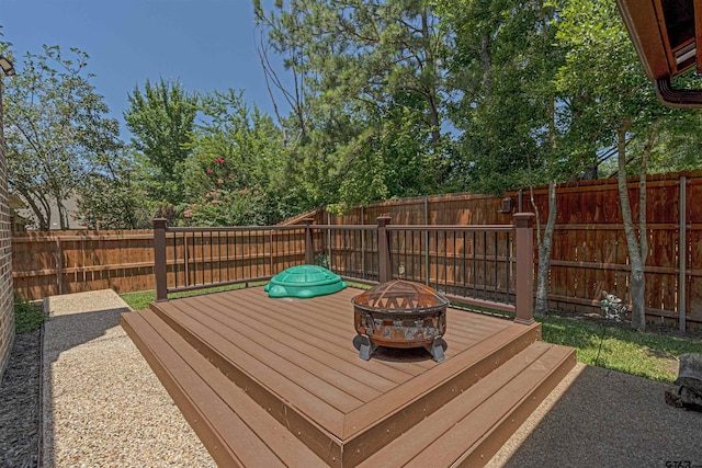 6530 Ashmore Ln, Tyler, TX 75703 - wooden terrace featuring a fire pit and a fenced backyard