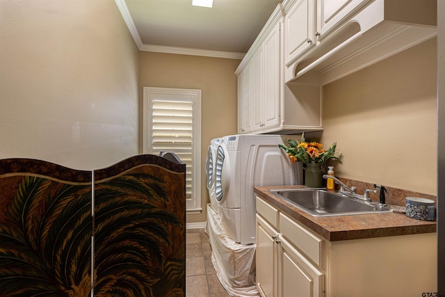 6530 Ashmore Ln, Tyler, TX 75703 - laundry room featuring washer and clothes dryer, crown molding, light tile patterned floors, and cabinet space