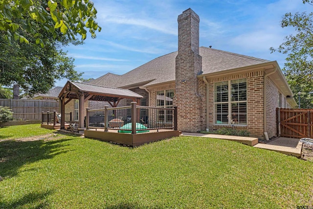 6530 Ashmore Ln, Tyler, TX 75703 - rear view of house featuring a gazebo, brick siding, a fenced backyard, and roof with shingles