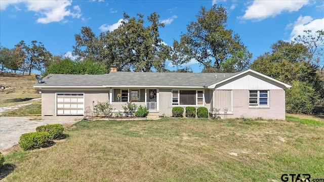 ranch-style house featuring a garage and a front yard