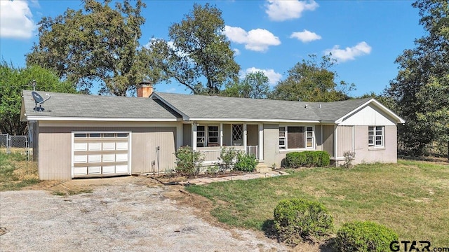 single story home with a garage and a front lawn