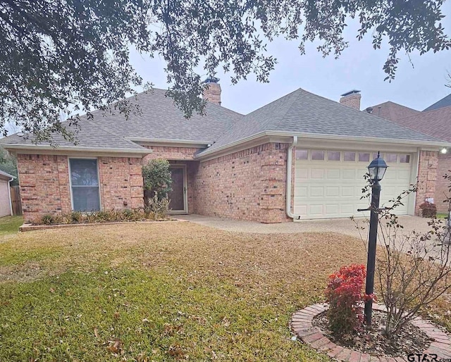 ranch-style home featuring a garage and a front yard