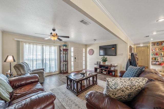 living room with ornamental molding and ceiling fan