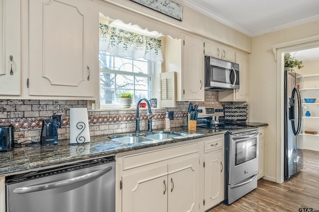 kitchen featuring white cabinets, appliances with stainless steel finishes, and sink