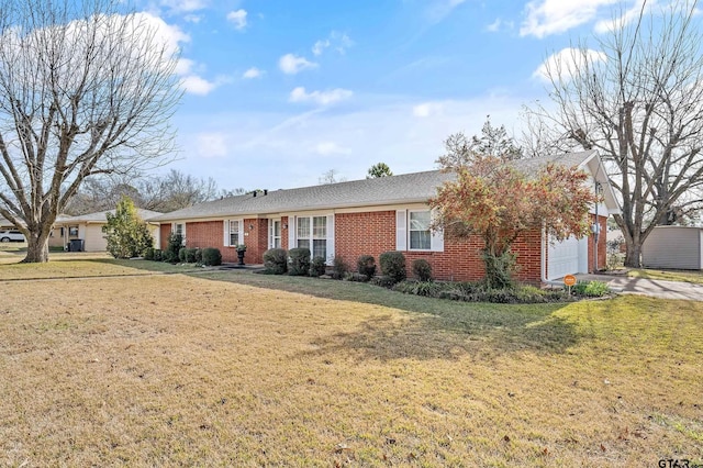 ranch-style home with a front yard and a garage