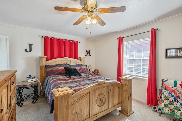 carpeted bedroom with ornamental molding and ceiling fan