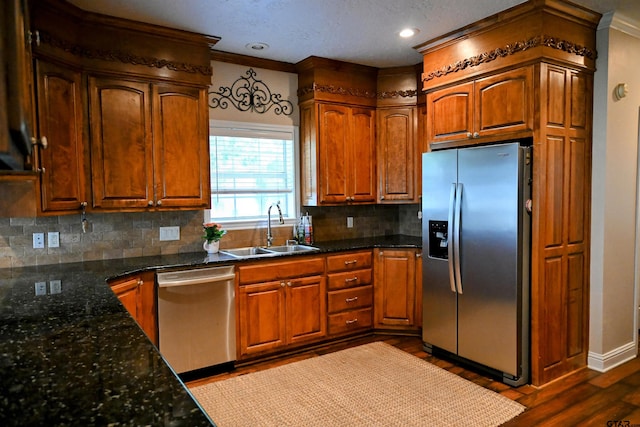 189 Candelara Dr, Carthage, TX 75633 - kitchen featuring stainless steel appliances, tasteful backsplash, dark wood-type flooring, ornamental molding, and dark stone counters