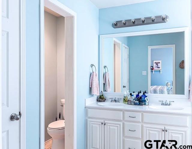 bathroom featuring vanity and toilet