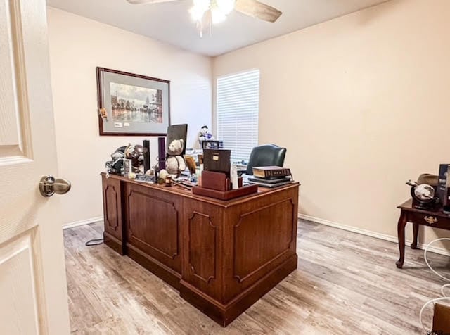 office space with ceiling fan, baseboards, and light wood-style floors