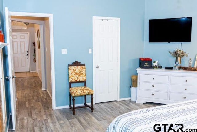 bedroom featuring light wood-style floors and baseboards