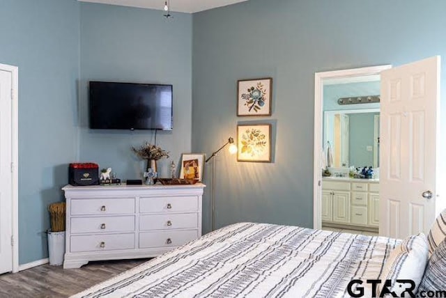 bedroom with wood finished floors and ensuite bathroom