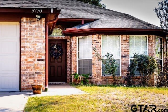 view of exterior entry with a garage