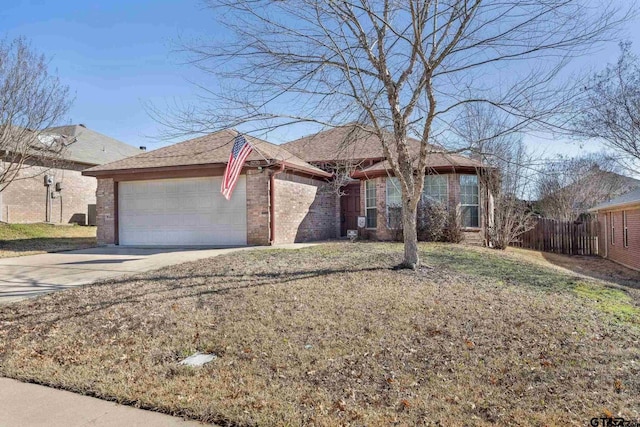 ranch-style house with fence, concrete driveway, a front yard, a garage, and brick siding