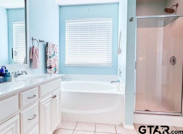 full bath with vanity, tile patterned floors, a garden tub, and a stall shower