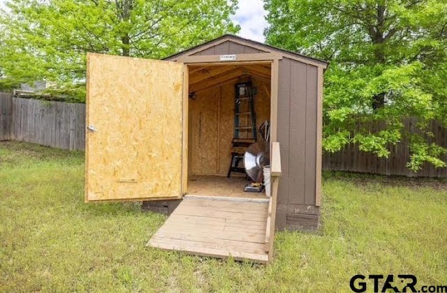 view of shed with fence