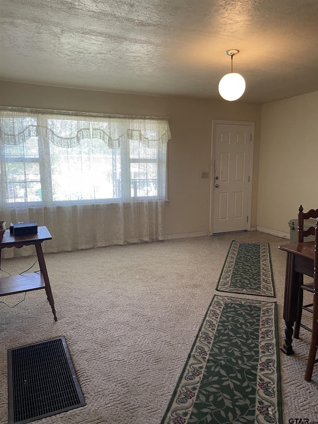 105 Walker Dr, Naples, TX 75568 - carpeted entrance foyer featuring visible vents, a textured ceiling, and baseboards