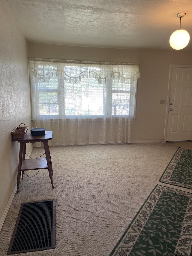 105 Walker Dr, Naples, TX 75568 - carpeted foyer entrance with a textured ceiling, baseboards, and visible vents