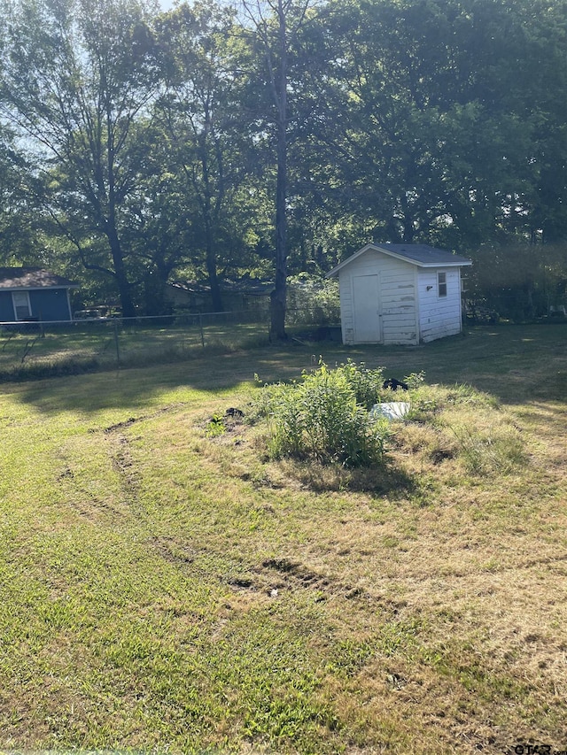 105 Walker Dr, Naples, TX 75568 - view of yard featuring an outbuilding, fence, and a storage unit