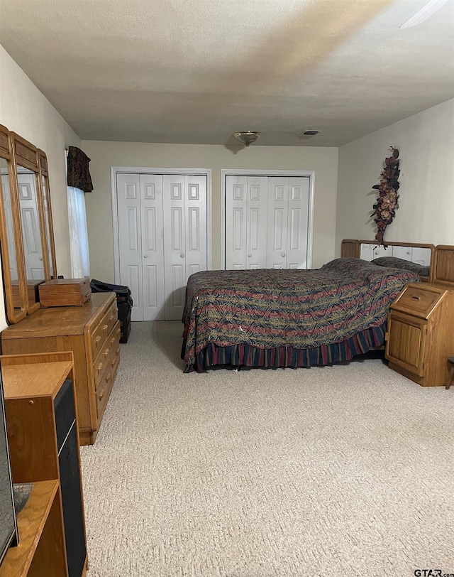 105 Walker Dr, Naples, TX 75568 - carpeted bedroom with visible vents and multiple closets