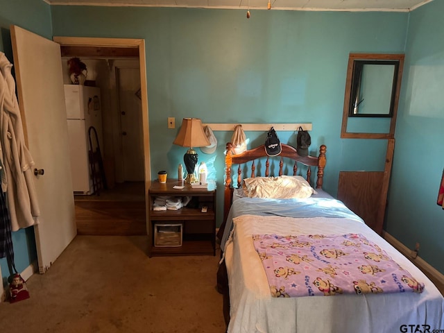 carpeted bedroom with white refrigerator