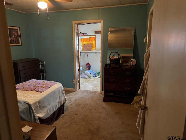 carpeted bedroom with ceiling fan and crown molding