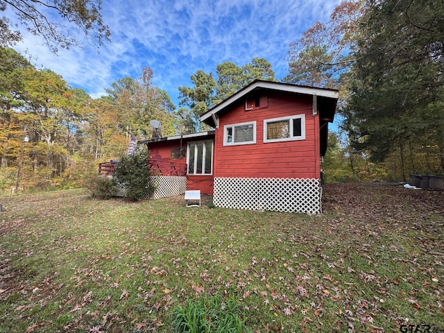 view of property exterior with a yard