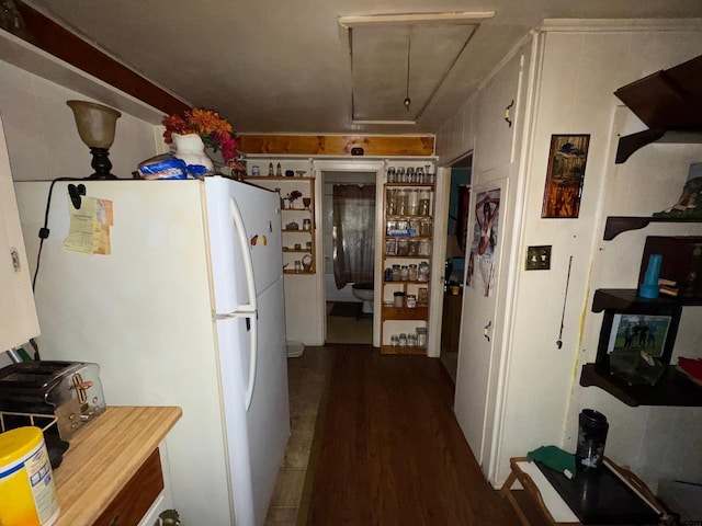 kitchen featuring white refrigerator and dark hardwood / wood-style flooring