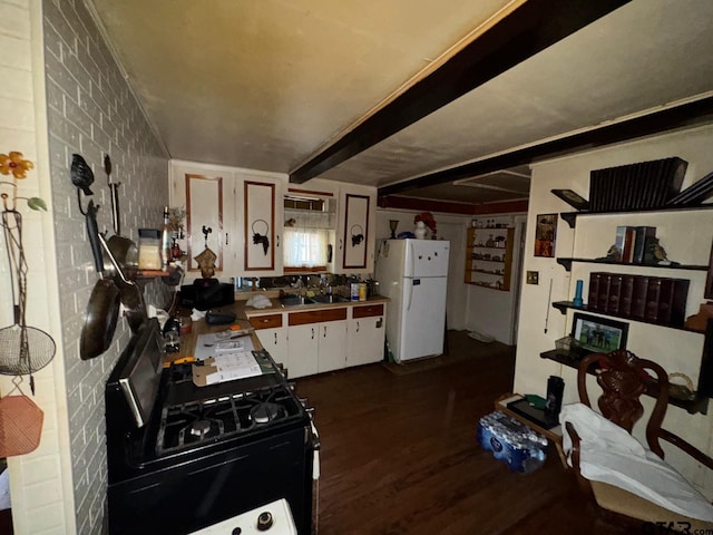 kitchen with dark hardwood / wood-style floors, beam ceiling, white fridge, black range with gas cooktop, and brick wall