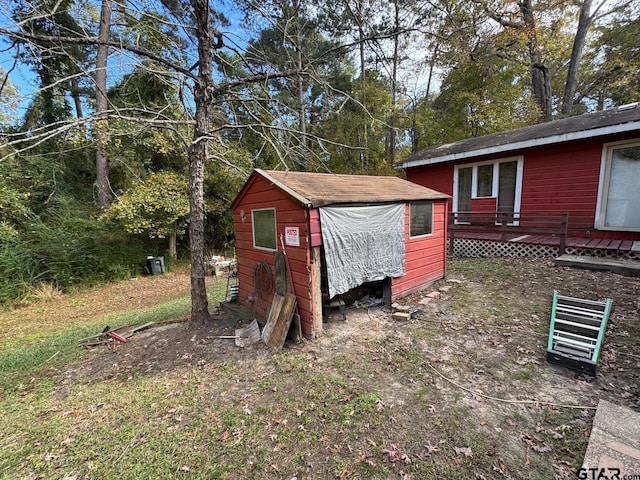 exterior space with a storage shed and a wooden deck