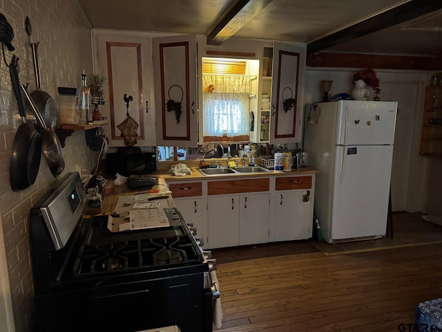 kitchen featuring sink, black appliances, beam ceiling, hardwood / wood-style flooring, and white cabinetry