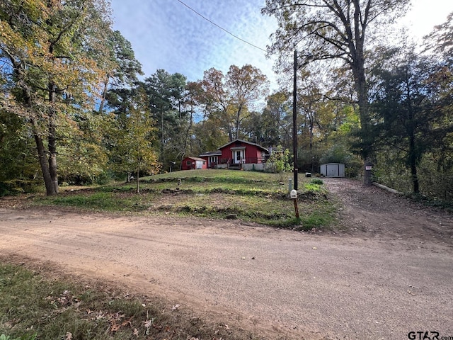 view of front of house with a storage unit