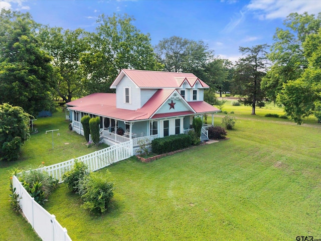 202 School St, Winfield, TX 75493 - view of front of home with a fenced backyard, a metal roof, view of scattered trees, and covered porch