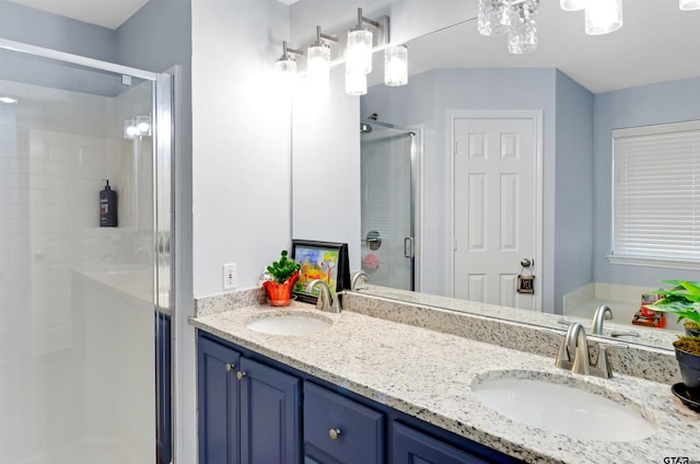 bathroom featuring vanity and a shower with door