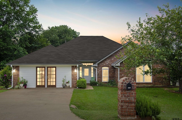 exterior space featuring french doors and a lawn