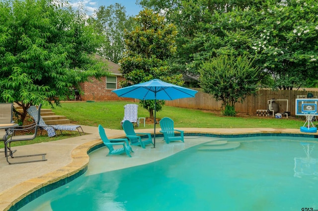 view of pool with a yard and a patio