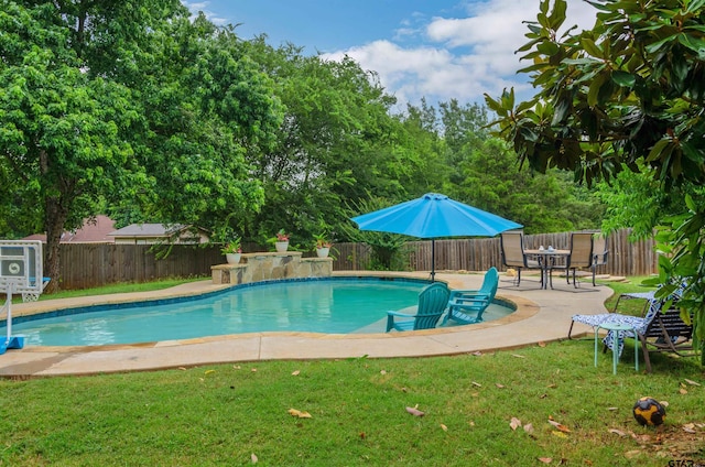 view of swimming pool featuring a patio area and a yard